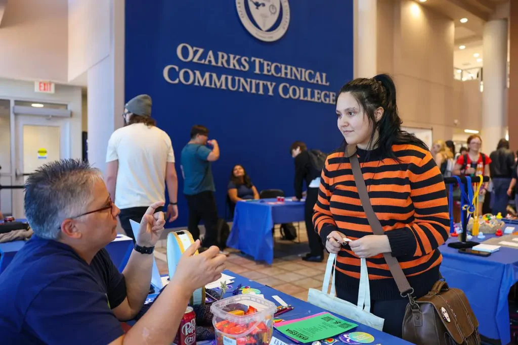 A student talks with a club representative during Club Rush at Ozarks Technical Community College.