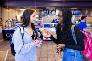 Two students share snacks inside Caf&eacute; 101 at OTC.