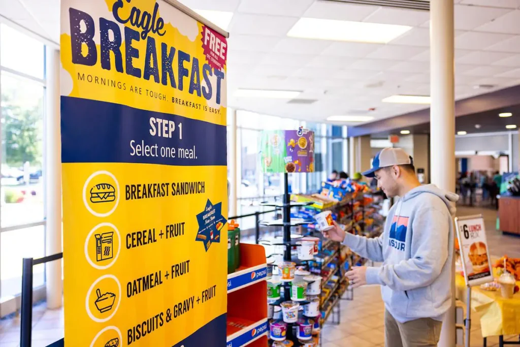 Student selects food items during the free Eagle Breakfast program at OTC.