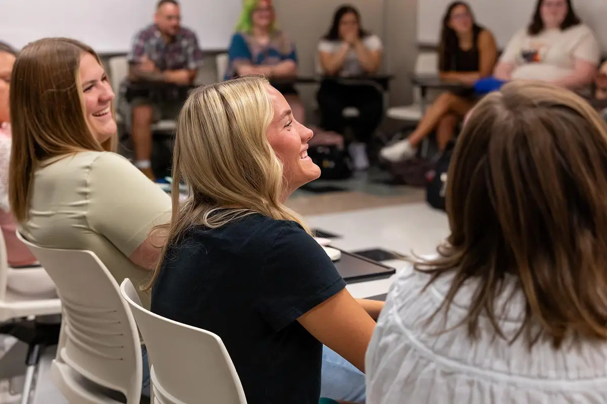 Students smiling and engaged during a classroom discussion at OTC.