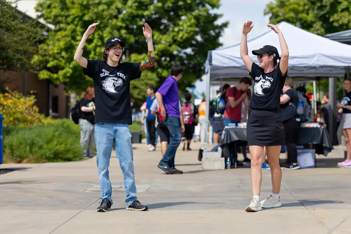 Students dance with raised arms during OTC’s Flock Party welcome event.