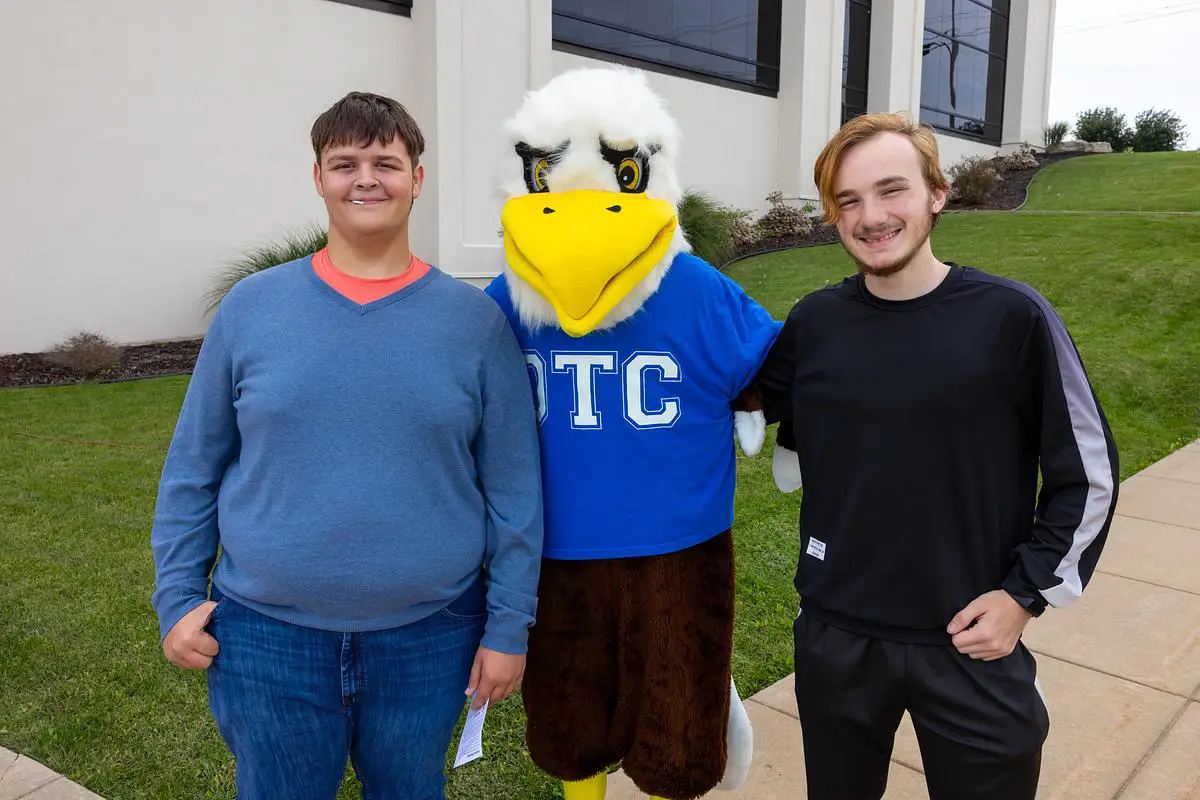 Two students pose with the OTC Eagle mascot outside Ozarks Technical Community College’s Table Rock Campus.