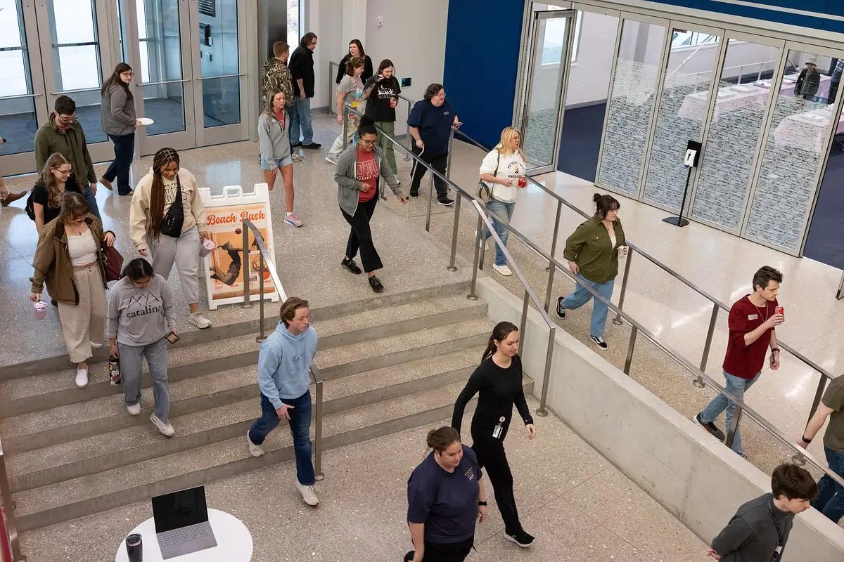 Students walk through the lobby of OTC&rsquo;s PMC building during a Beach Bash and Trivia Night event.