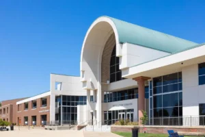 Exterior of the Information Commons building at Ozarks Technical Community College on a clear blue day.
