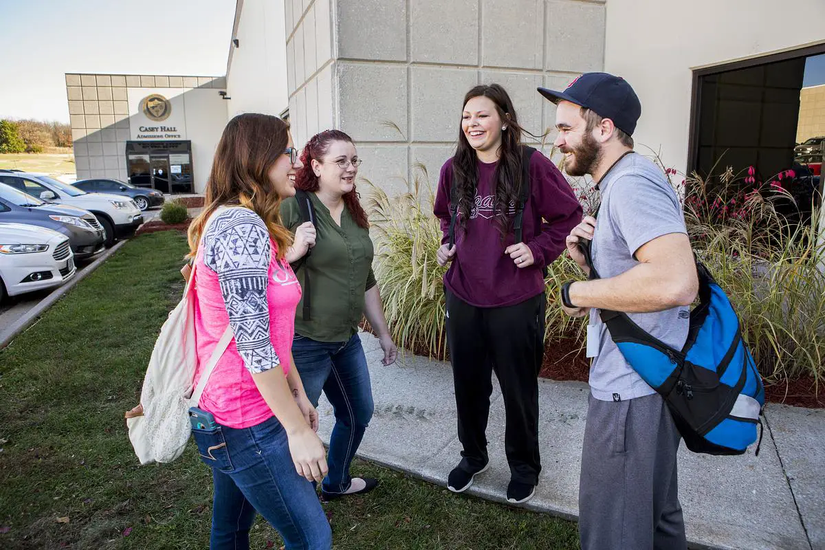 Group of students talking and smiling outside Casey Hall at Ozarks Tech&rsquo;s Lebanon campus.