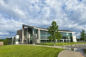 Exterior of Ozarks Technical Community College’s Richwood Valley Campus building under a partly cloudy sky.