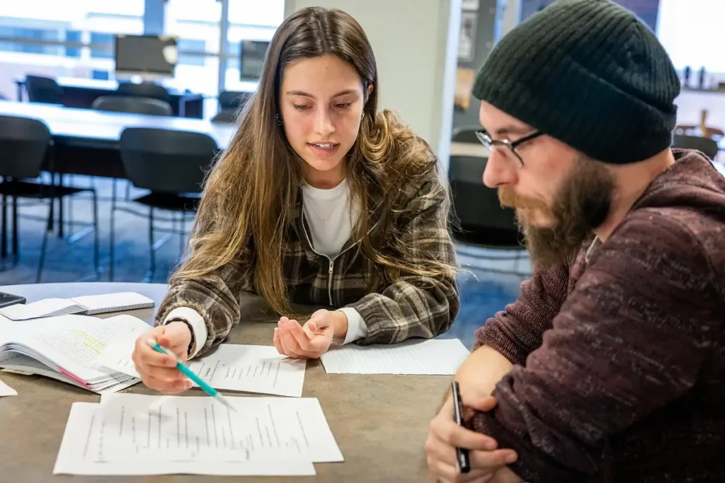 Two OTC students work together on writing assignments at the Writing Center.
