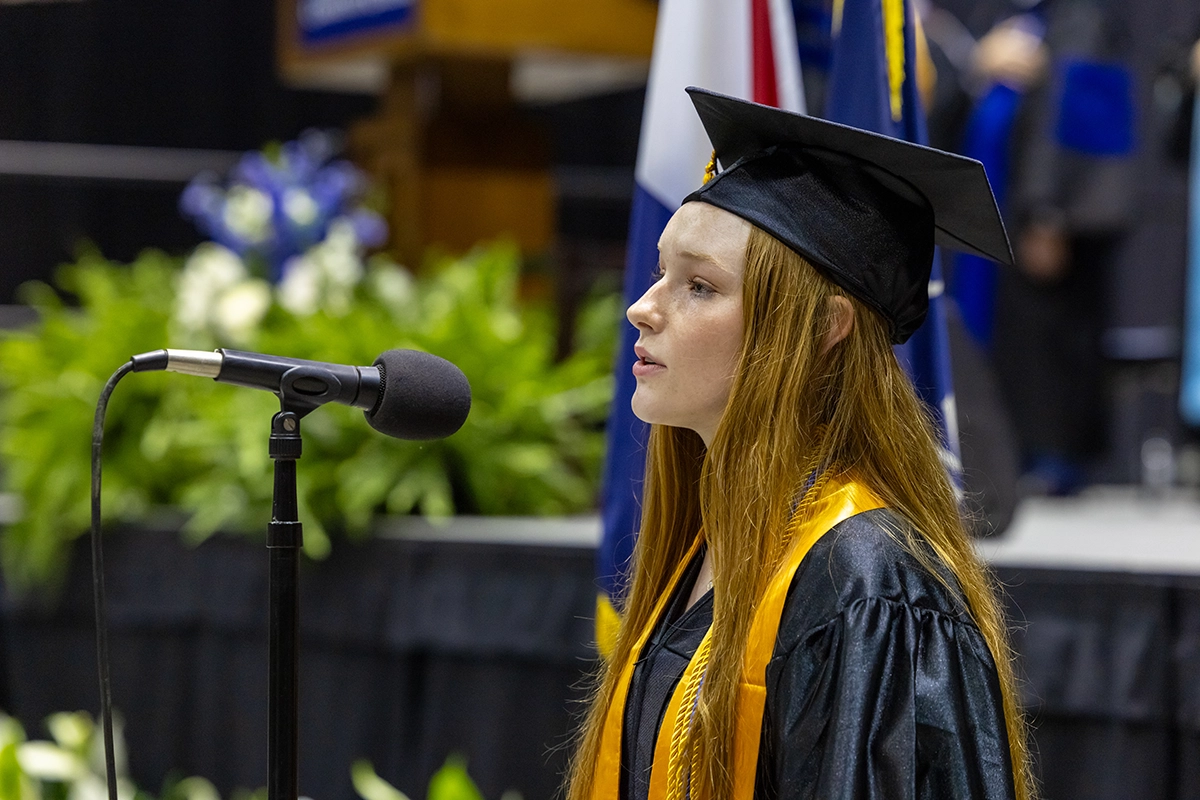 Student singing National Anthem