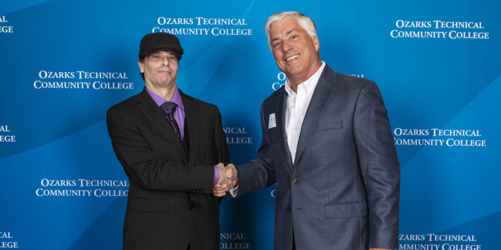 Ozarks Tech graduate Lee Brubaker is depicted shaking hands with OTC Donor Jim Towery 