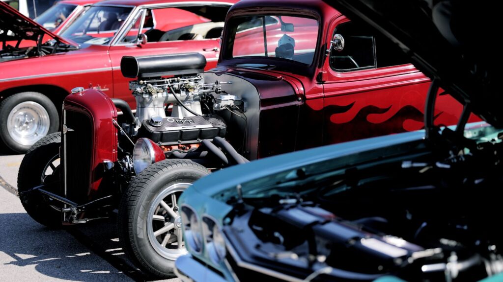 Several exotic cars are depicted with their engines visible
