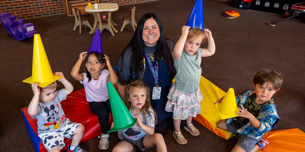 Ozarks Tech Early Childhood Education Center Teacher Chelsey Wright is depicted with a group of young students.