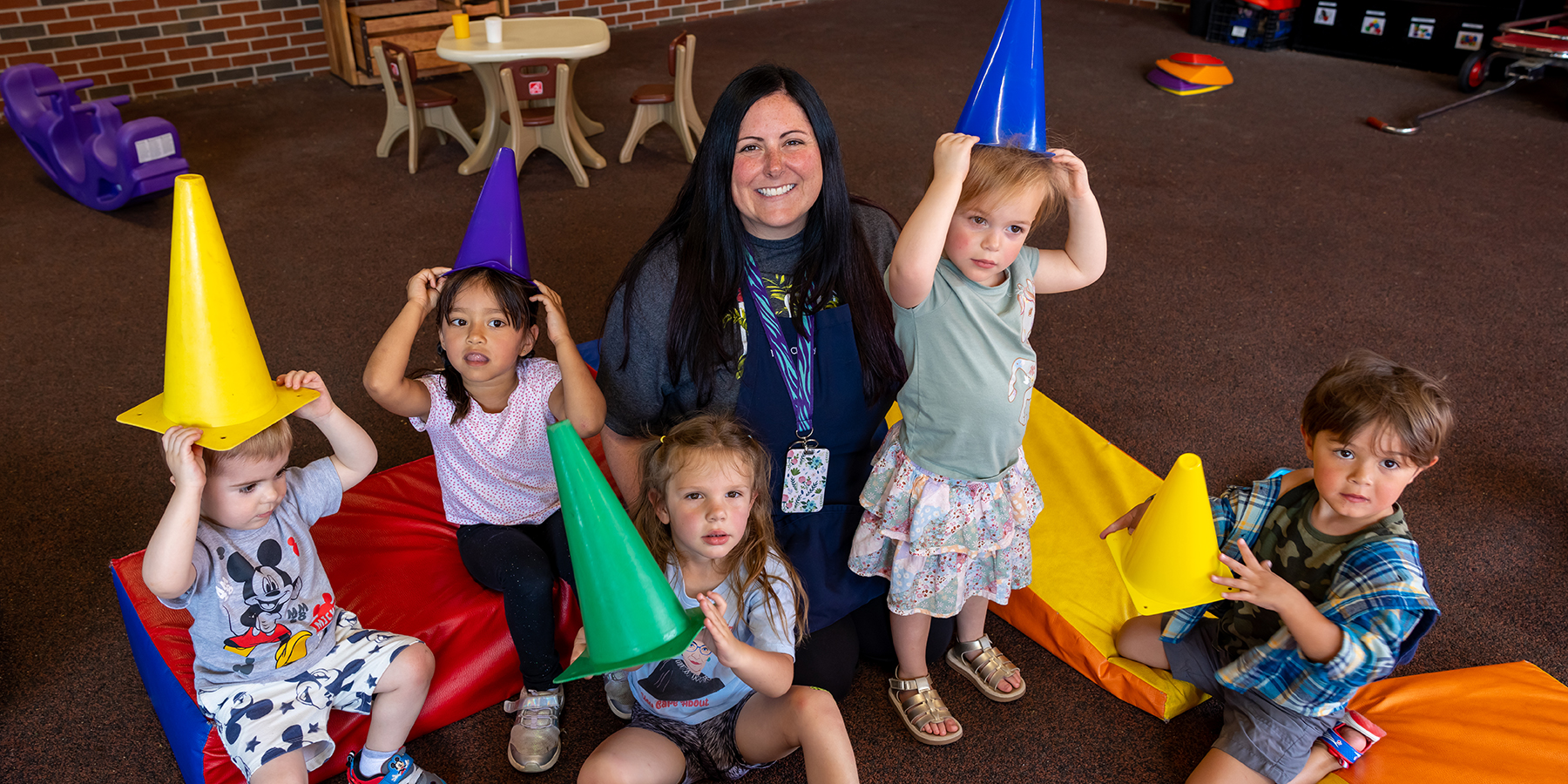 Ozarks Tech Early Childhood Education Center Teacher Chelsey Wright is depicted with a group of young students.