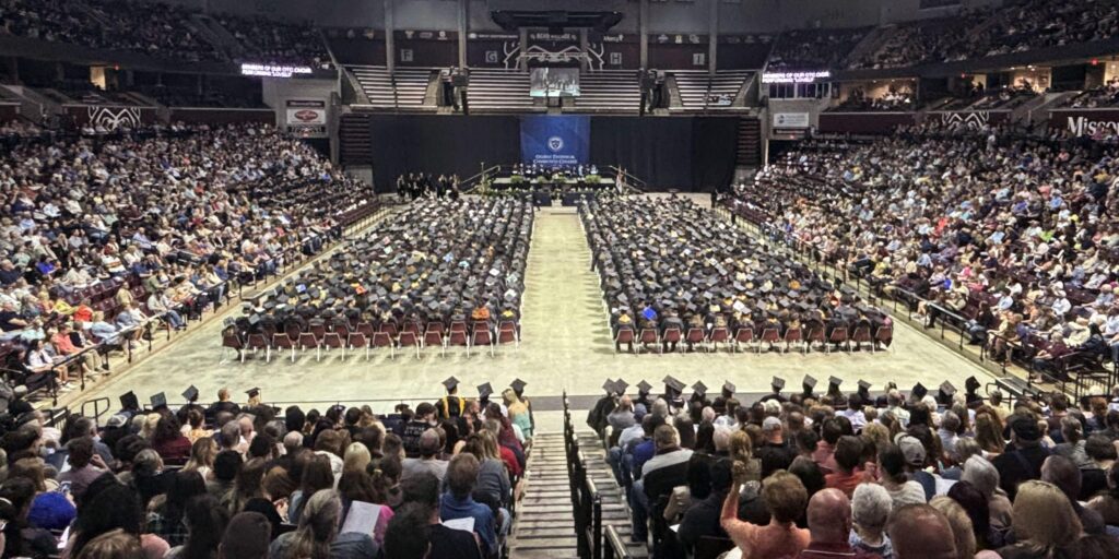 Graduating students and guests are depicted attending Ozarks Tech's commencement ceremony