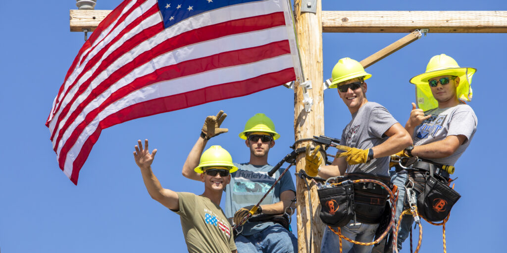 Ozarks Tech Lineworker students are depicted at the top of a pole during the Lineworker Rodeo