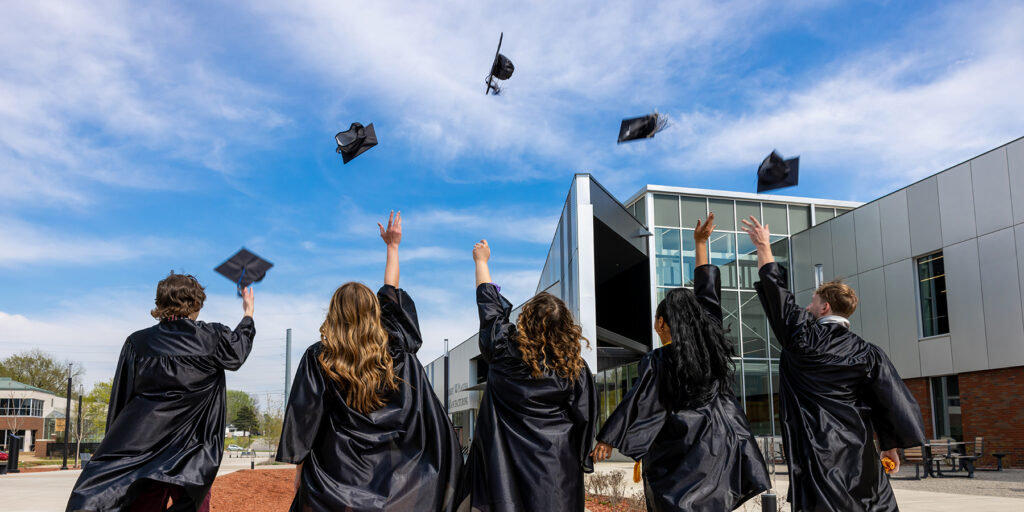 Ozarks Tech graduates are depicting tossing their caps