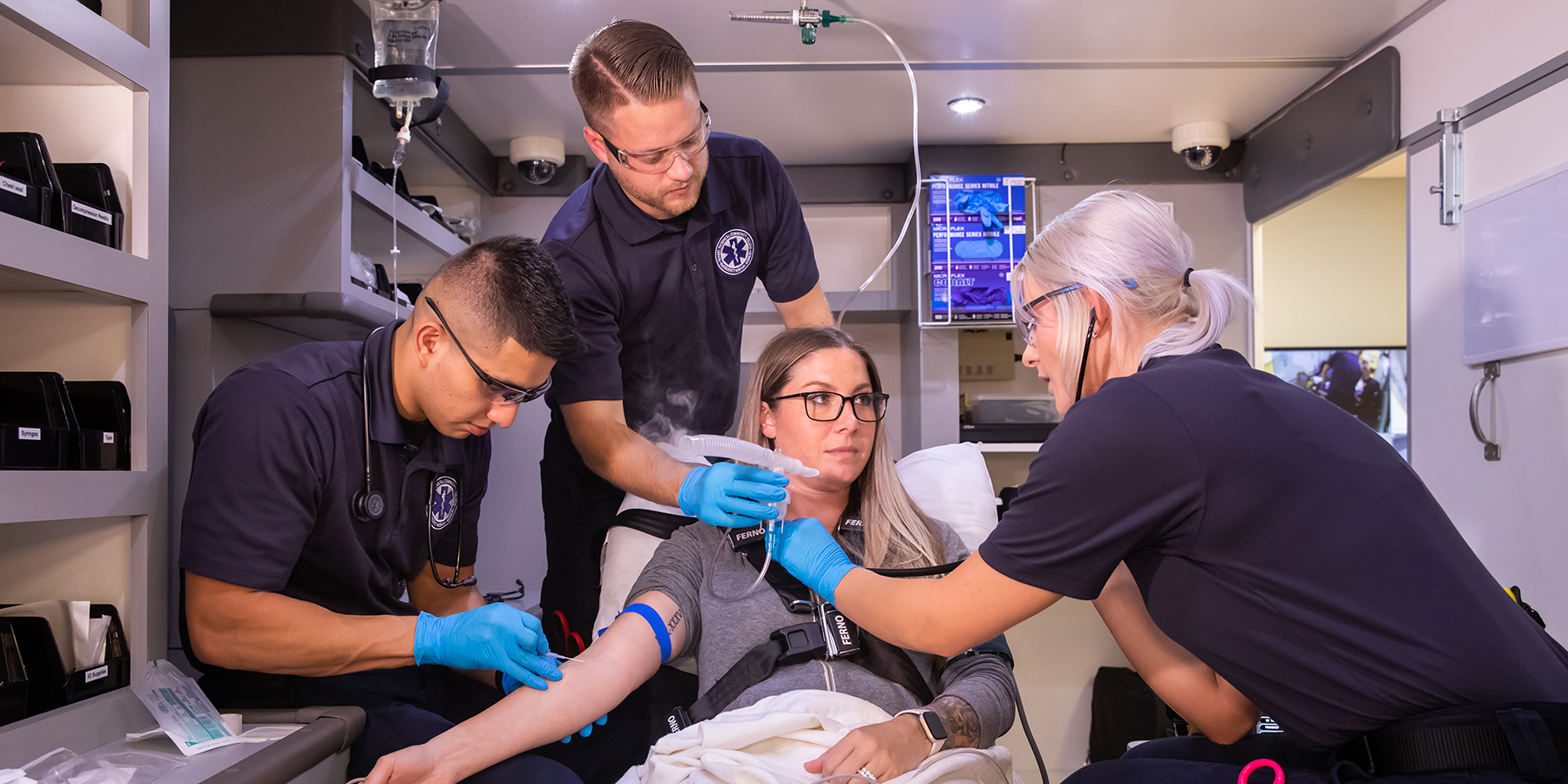 Paramedicine Program students work in the ambulance simulation lab.
