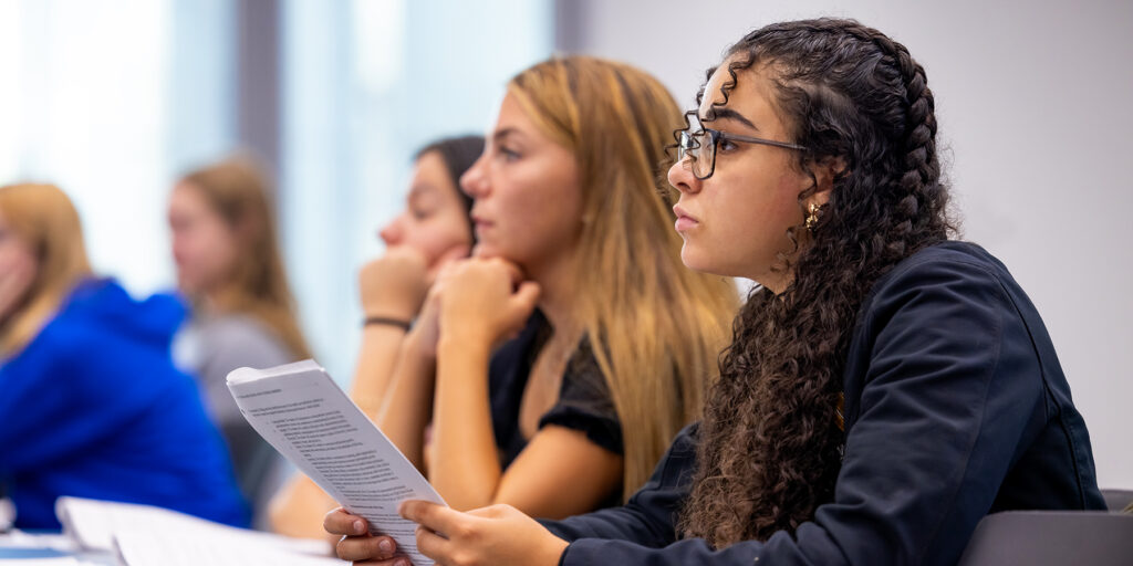 Students are depicted attending a lecture