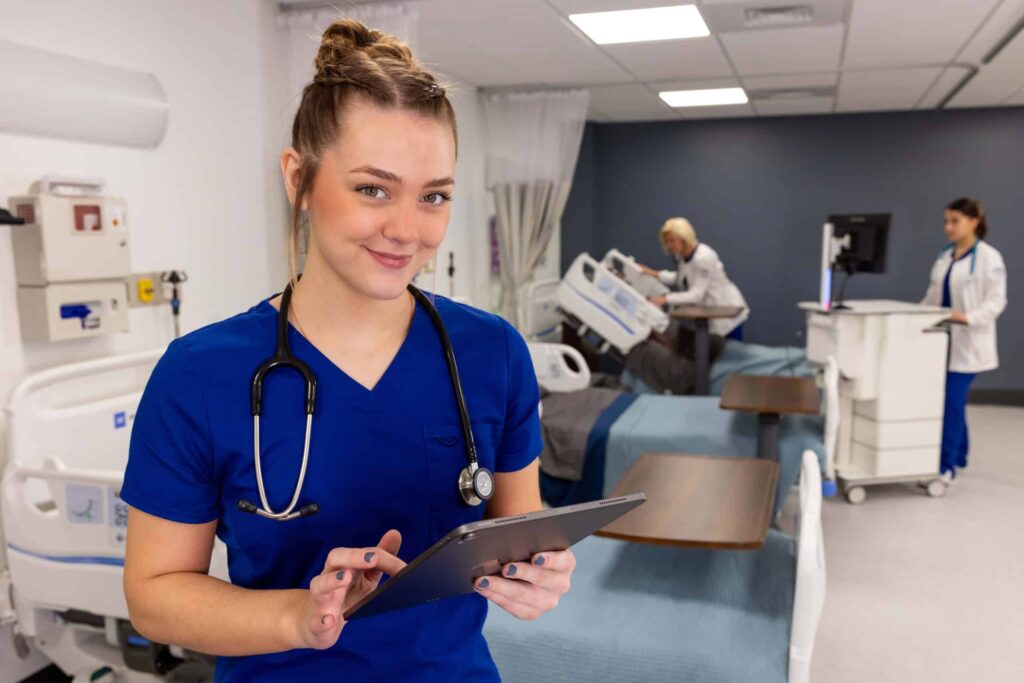 An Ozarks Tech Nursing student is depicted holding an iPad