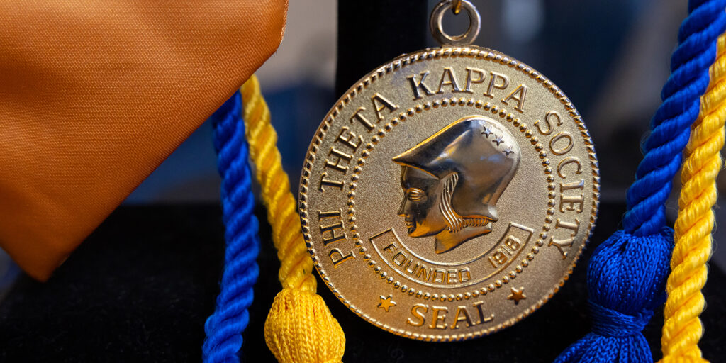 A Phi Theta Kappa medal is depicted