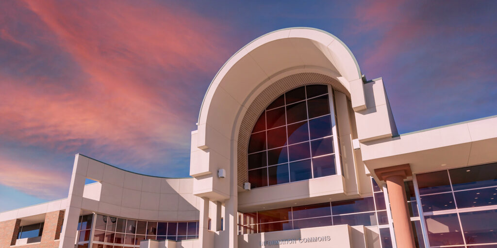Ozarks Tech's Information Commons building is depicted against a vibrant sunset