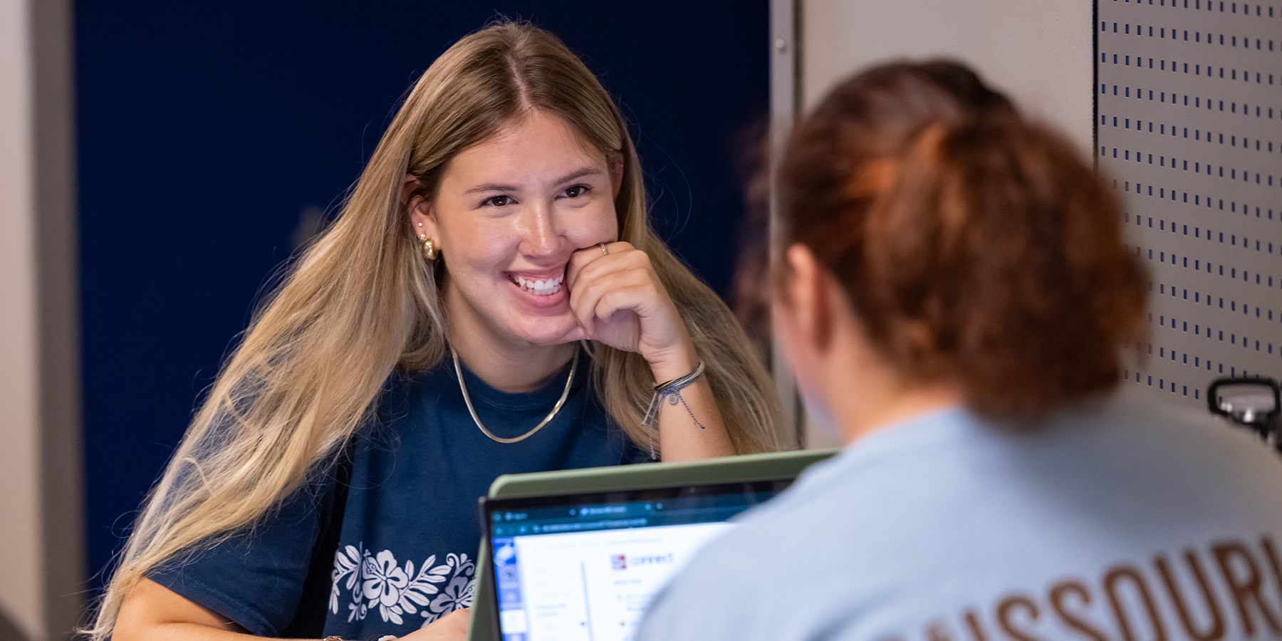 A student is depicted consulting their College Navigator