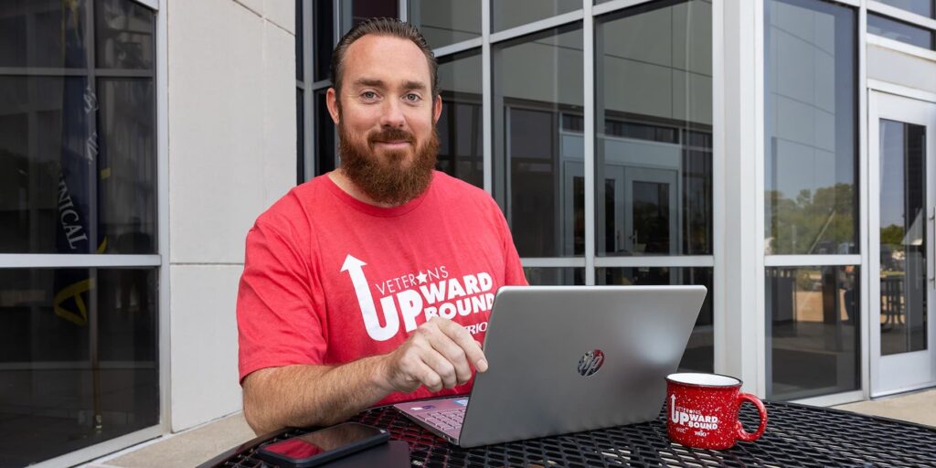 Ozarks Tech student John Larson is depicted using a laptop computer