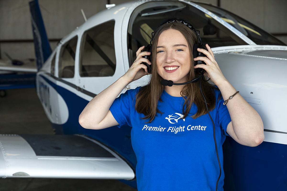 Aviation student in front of a small plane