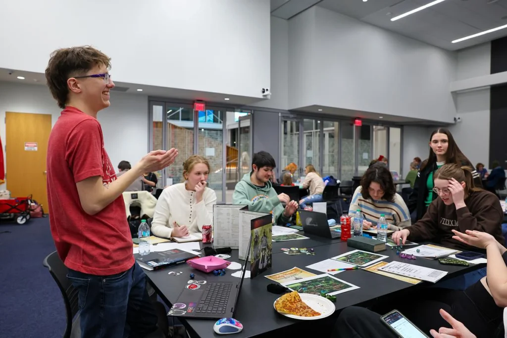 Students sitting around a table playing a game