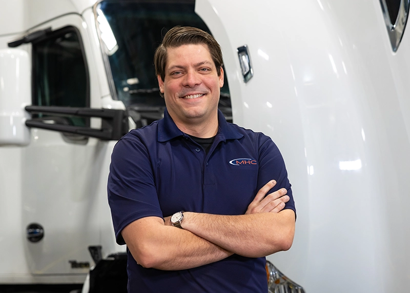 Paul Decker stands in front of an 18 wheeler truck cab