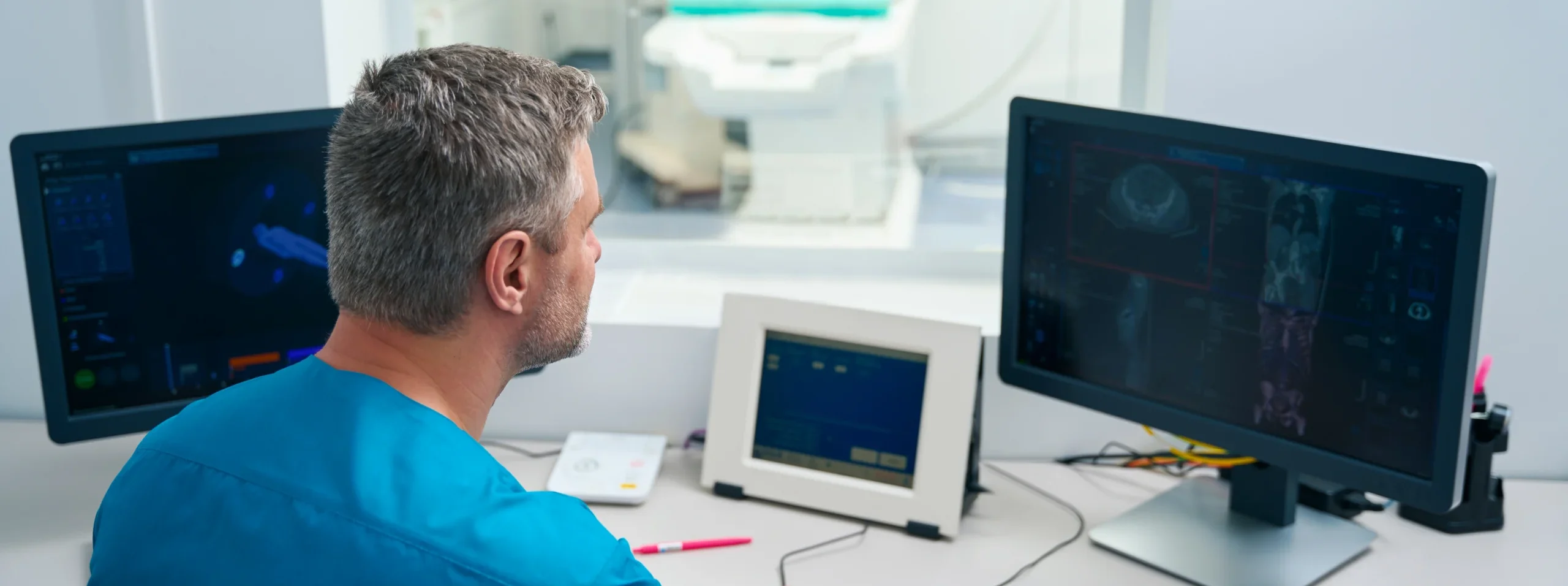 Technician reviews imaging on a computer screen.