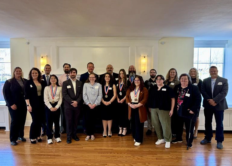 Group shot of Phi Theta Kappa student members and faculty advisors attending an awards ceremony