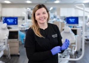 Alex Smith, a dental hygiene student, smiles in a dental lab