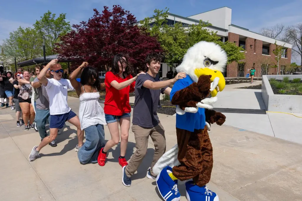 Students dance in a line with Ozzy at the fall picnic
