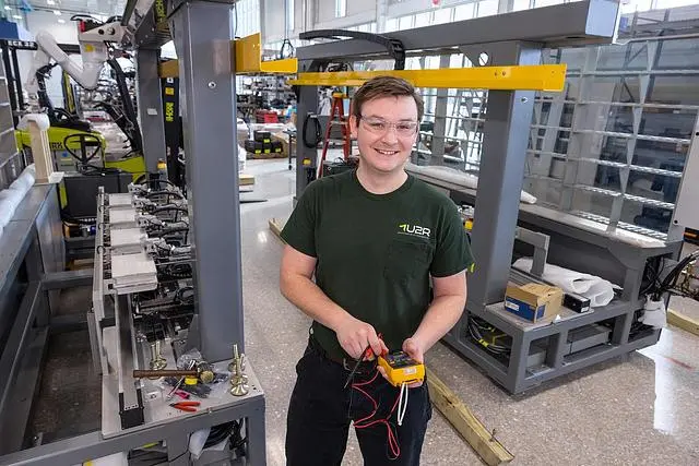 Engineering student smiles in lab