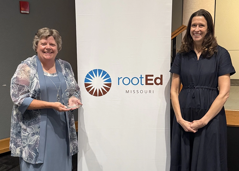 Portrait of Susan Rupert receiving Advisor of the Year award