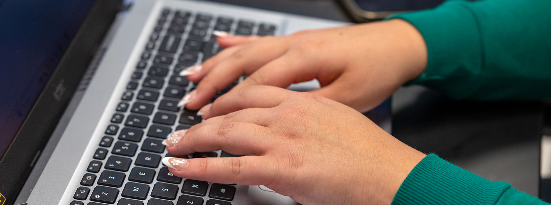 Hands on a laptop keyboard